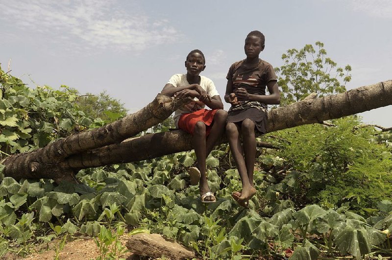 Tabu Sunday, 14, sits with his twin sister, Rena, in a refugee settlement in southern Uganda. U.N. High Commissioner for Refugees has designated Tabu the 1 millionth South Sudanese to arrive in Uganda.