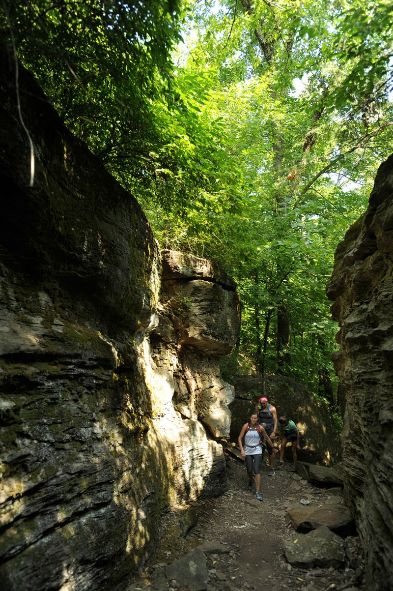 Residents hike through Rock City along the trail on Mount Kessler in Fayetteville.