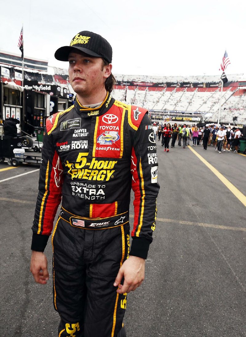 Erik Jones makes his way through the pit area after qualifying for a NASCAR Cup Series auto race, Friday, Aug. 18, 2017, in Bristol, Tenn. Jones will start on the pole for Saturday's race. 