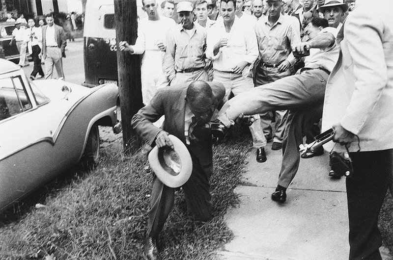 Black newspaperman Alex Wilson is kicked by an attacker in a group of integration foes near Central High School on Sept. 23, 1957. He was seriously injured.