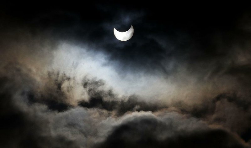 A partial solar eclipse was seen from Gaza City in 2011. On Monday, a solar eclipse will cross America for the first time in 99 years, and believers across all faiths will put into practice different eclipse traditions.