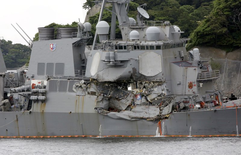 In this June 18, 2017, file photo, damaged USS Fitzgerald is docked at the U.S. Naval base in Yokosuka, southwest of Tokyo, after colliding with Philippine-flagged container ship ACX Crystal off Japan.