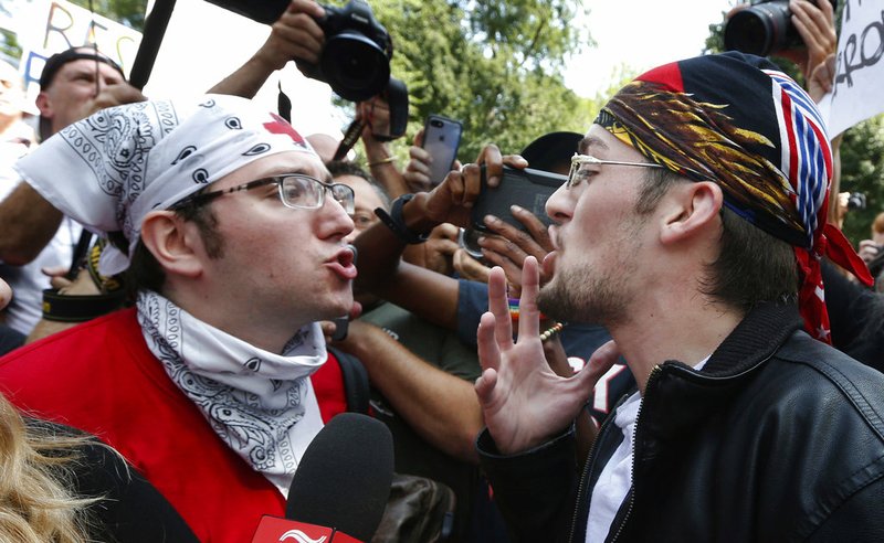 A counterprotester, left, confronts a professed supporter of President Donald Trump at a "Free Speech" rally by conservative activists on Boston Common, Saturday, Aug. 19, 2017, in Boston. 