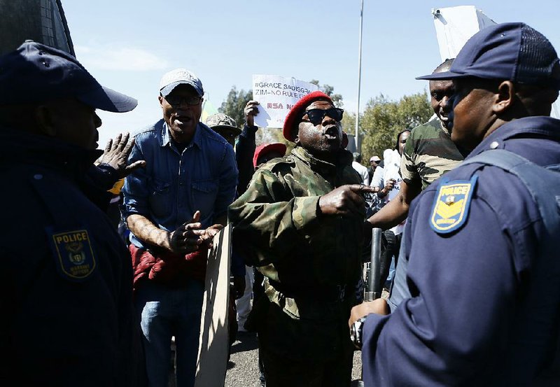 People protest Saturday in Pretoria, South Africa, against Zimbabwean first lady Grace Mugabe.