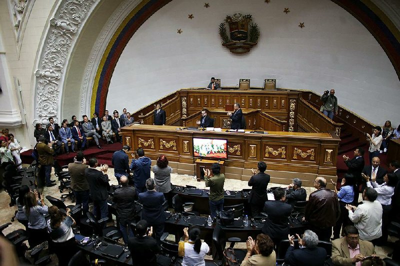 Some foreign diplomats (left) receive applause Saturday for their show of solidarity with Venezuelan lawmakers during a special session of Venezuela’s National Assembly in Caracas.