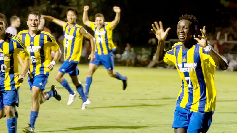 Photo courtesy of JBU Sports Information John Brown University men&#8217;s soccer players celebrate after scoring a goal against Southwest Baptist (Mo.) during an early-season game in 2016.