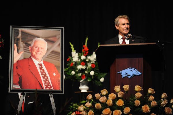 Jack Broyles, the eldest son of Frank Broyles, speaks alongside a portrait of Frank Broyles Saturday, Aug. 19, 2017, during a celebration in Bud Walton Arena on the University of Arkansas campus in Fayetteville for the life of Frank Broyles, the former coach and athletics director, who died Monday at 92.