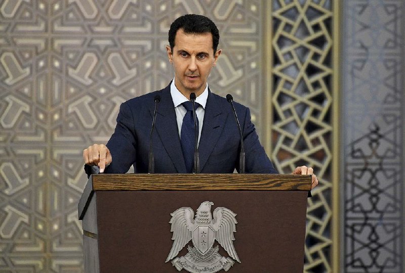 Syrian President Bashar Assad speaks to Syrian diplomats Sunday in the capital, Damascus, in this photo released by the official Facebook page of the Syrian presidency.
