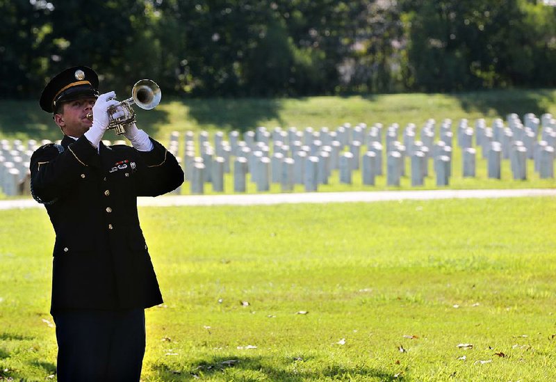 Bugler cadet Justin Karp plays taps during the funeral service Friday for Audrey Straight Wolfe Jr. at the Arkansas State Veterans Cemetery at North Little Rock. Officials are looking into expanding burial space at the cemetery after a recent uptick in burials.