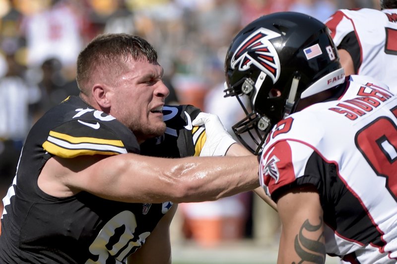 Pittsburgh Steelers linebacker T.J. Watt (90), left, continues to try to get past Atlanta Falcons tight end Eric Saubert (85) after losing his helmet in the first half of an NFL preseason football game, Sunday, Aug. 20, 2017, in Pittsburgh. 