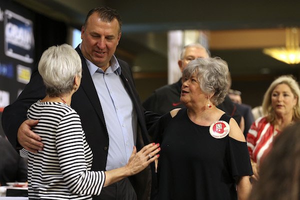 Arkansas Razorbacks head coach Bret Bielema (left center) meets with fans before speaking to the Little Rock Touchdown Club on Monday, Aug. 21, 2017, at the Embassy Suites hotel in Little Rock.