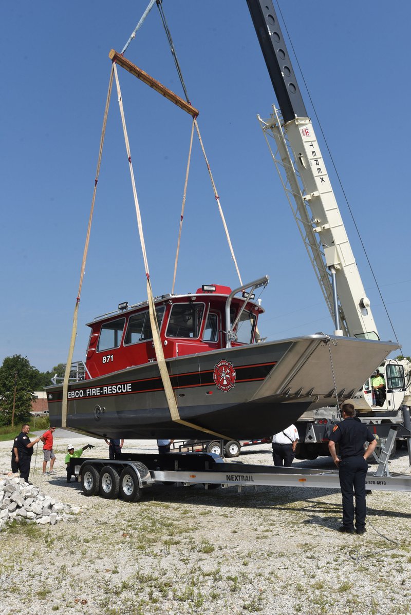Firefighters with the Northeast Benton County Fire Department move a new fire and rescue boat to a trailer April 9 at the main fire station in Garfield.