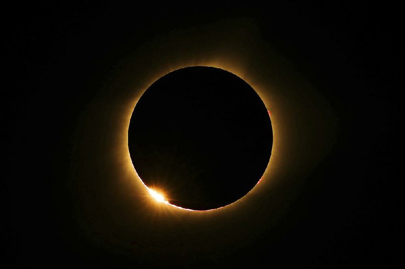 The moon passes in front of the sun for a total solar eclipse visible Monday from Farmington, Mo.