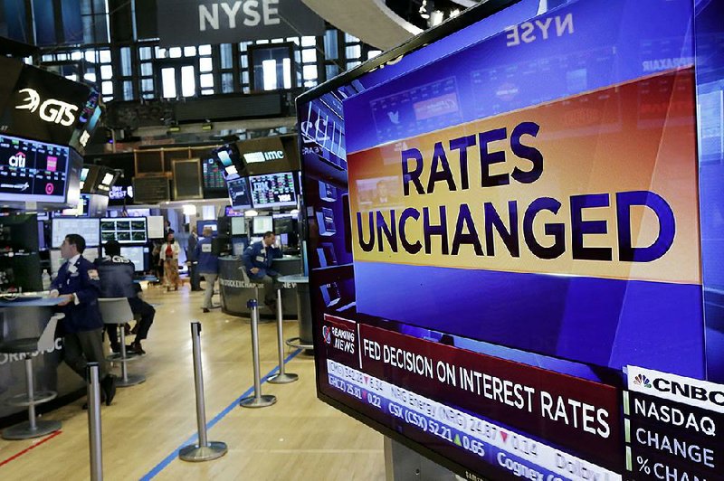 A television screen on the floor of the New York Stock Exchange shows the Federal Reserve’s July 26 rate decision. The Federal Reserve kept its benchmark interest rate unchanged at a time of low inflation, which remains persistently below the Fed’s target level.