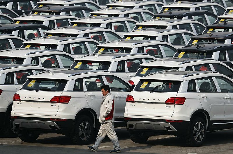 A worker walks past Haval SUV models parked outside the Great Wall Motors assembly plant in Baoding in China’s Hebei province in February. Great Wall is considering a bid for Fiat Chrysler’s Jeep unit.