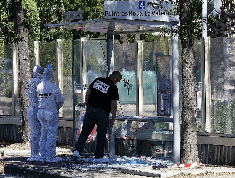 Police officers inspect a bus stop in La Valentine district after a van rammed into two bus stops in the French port city of Marseille, southern France, on Monday.