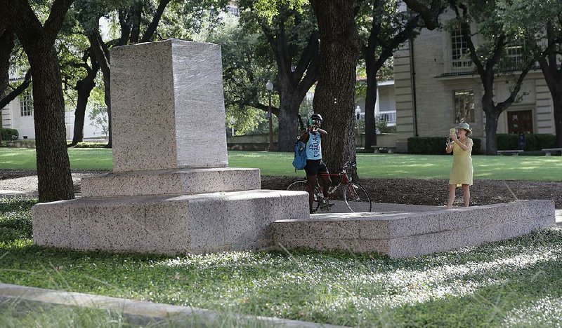 A pedestal is wrapped in plastic that had held a statue of Confederate Gen. Robert E. Lee which was removed from the University of Texas campus early Monday in Austin, Texas.
