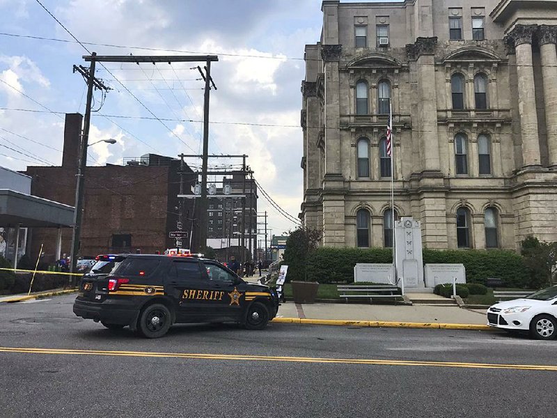 This image made from video provided by WTOV-TV in Steubenville, Ohio, shows a police vehicle responding to the ambush-style shooting of a Jefferson County judge as he walked to the Jefferson County Courthouse.