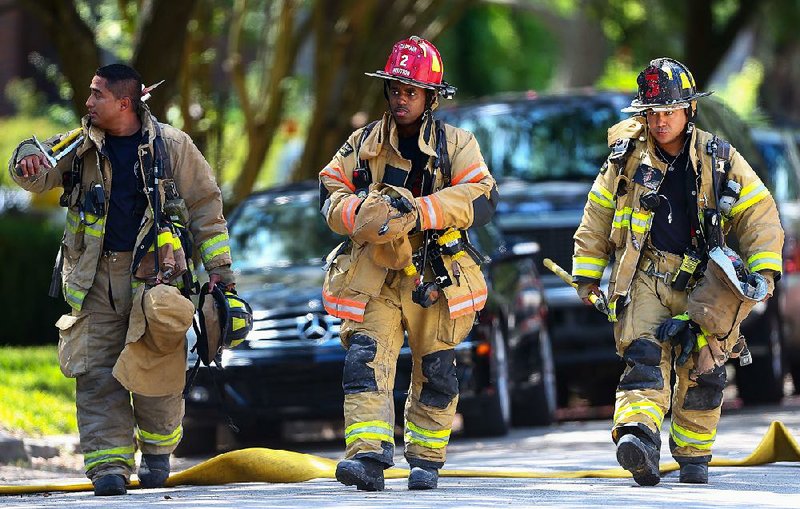 Houston firefighters arrive on the scene after a man was charged with trying to plant explosives at the statue of Confederate officer Richard Dowling in Houston.