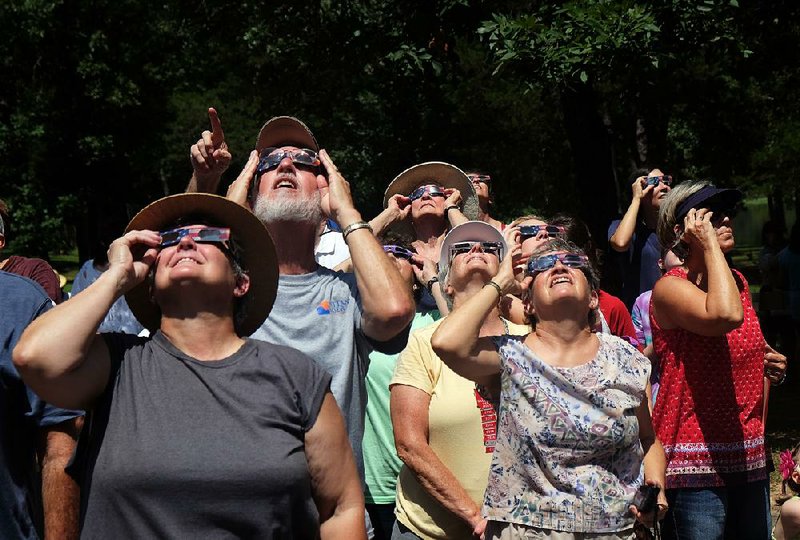 People watch the solar eclipse Monday from Petit Jean State Park near Morrilton. About 100 people attended the eclipse watch party atop Petit Jean Mountain.