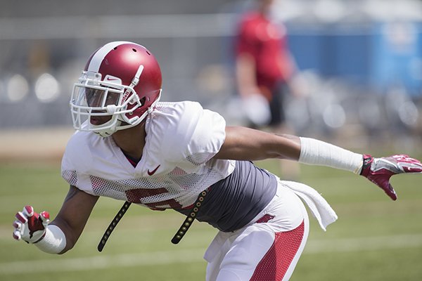 Arkansas cornerback Henre Toliver goes through drills Saturday, April 8, 2017, in Fayetteville. 