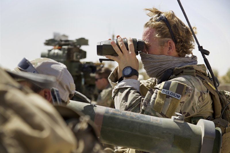 A Belgian special forces soldiers looks through his binoculars near the frontline, east of Tal Afar, Iraq, Sunday, Aug. 20, 2017. 