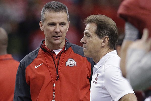 Ohio State head coach Urban Meyer, left, speaks with Alabama head coach Nick Saban before the Sugar Bowl NCAA college football playoff semifinal game, Thursday, Jan. 1, 2015, in New Orleans. (AP Photo/Brynn Anderson)
