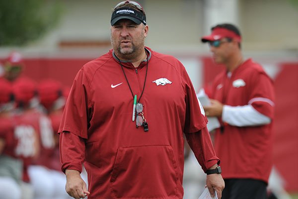 Arkansas coach Bret Bielema watches warmups prior to practice Tuesday, Aug. 1, 2017, in Fayetteville. 