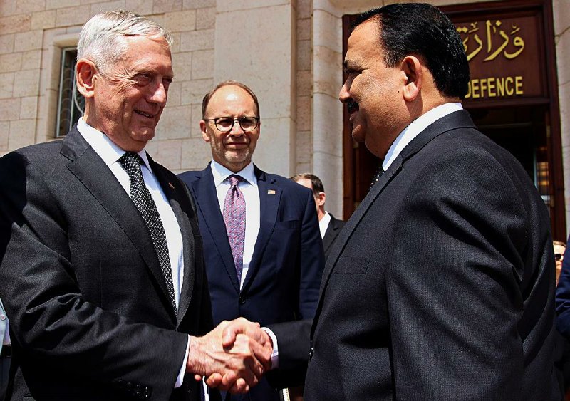 Iraqi Defense Minister Erfan al-Hayali (right) welcomes U.S. Defense Secretary James Mattis (left) and U.S. Ambassador to Iraq Douglas Silliman on Tuesday in Baghdad.