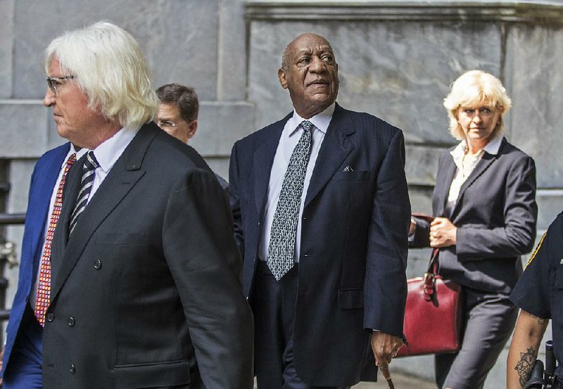 Bill Cosby, flanked by members of his new legal team, Tom Mesereau and Kathleen Bliss, leaves the courthouse after a hearing Tuesday in Norristown, Pa.