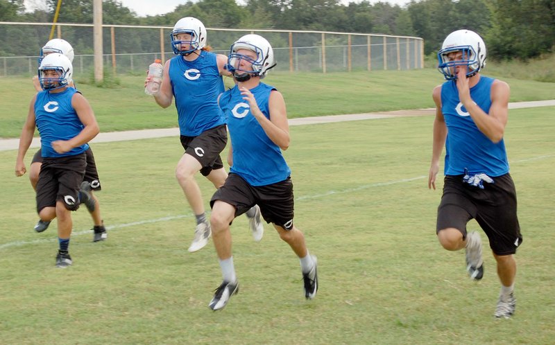 Graham Thomas/Herald-Leader Colcord (Okla.) football players run sprints at the end of practice on Aug. 9.