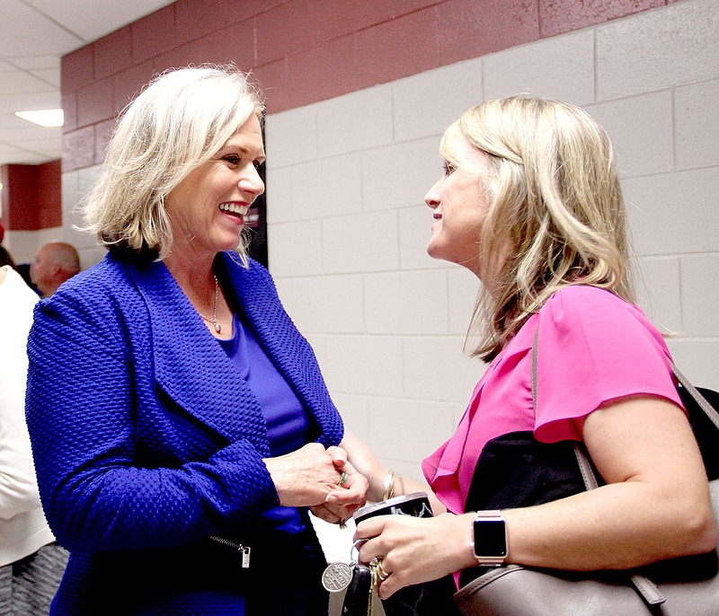 LYNN KUTTER ENTERPRISE-LEADER Motivational speaker Kim Hodous of Fayetteville, left, visits with Jill Jackson, principal of Lincoln Elementary School. Hodous spoke to Lincoln teachers during their district-wide meeting held Aug. 10 in the auditorium at Lincoln Middle School.