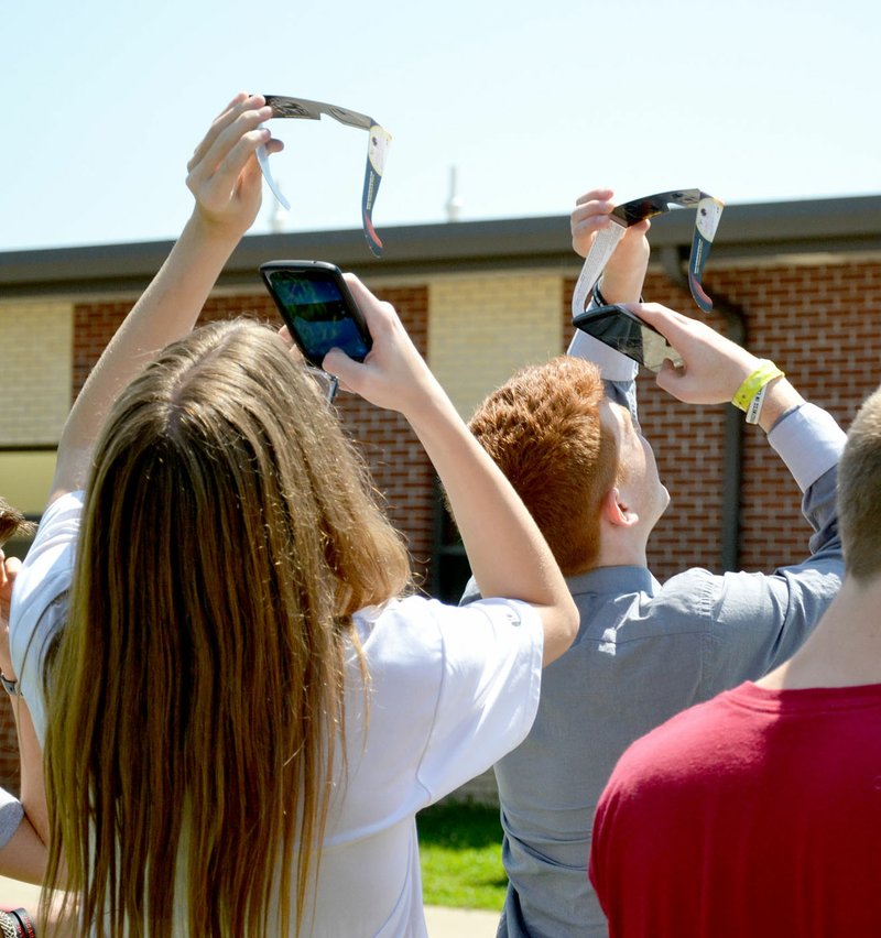 TIMES photograph by Annette Beard Freshmen Cheyenne Rust, Sophia Aldaco, Maddisyn Robinson and Hailee Hayes worked on an experiment during lab for physical science under the instruction of coach Josh Ferrell setting up a model of a solar eclipse Monday morning.
