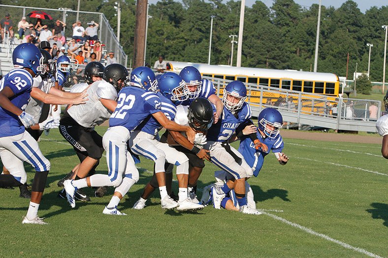 Terrance Armstard/News-Times A host of Parkers Chapel defenders struggle to drag down a Smackover ball carrier. The teams held a scrimmage Tuesday at Parkers Chapel.