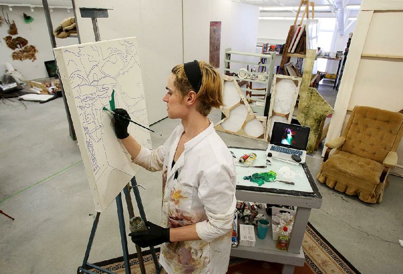 Hannah McBroom, a second-year master’s of fine arts student at the University of Arkansas, Fayetteville, works in her studio Wednesday in the $9.3 million Arts and Design District Sculpture Studio, which opened to students in the spring. McBroom said she was glad the Walton foundation gift included money for scholarships.  