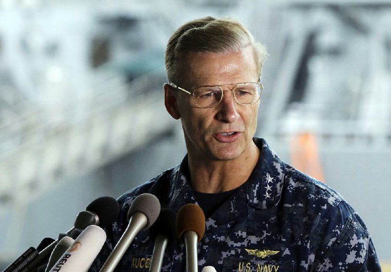 In this June 18, 2017, file photo, U.S. Navy Vice Adm. Joseph Aucoin, Commander of the U.S. 7th Fleet, speaks during a press conference, with damaged USS Fitzgerald as background at the U.S. Naval base in Yokosuka, southwest of Tokyo.