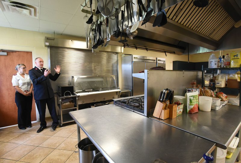 NWA Democrat-Gazette/FLIP PUTTHOFF Salvation Army Capts. Ashley and Joshua Robinett present the commercial kitchen at the Bentonville shelter during an open house and tour last week. During 2016, Salvation Army centers in Northwest Arkansas served 93,500 meals.