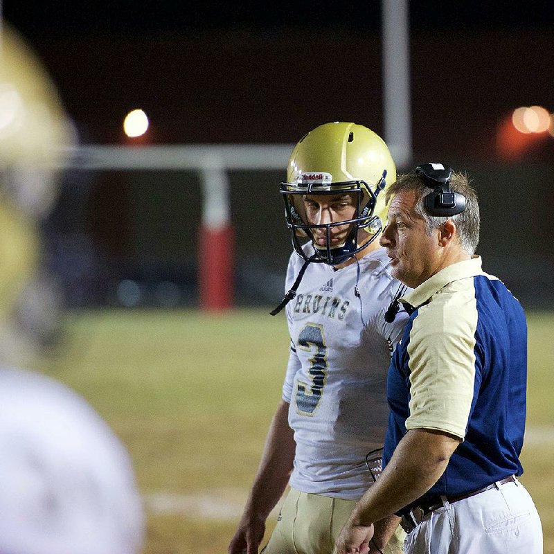 Pulaski Academy Coach Kevin Kelley (right) agreed last year to get a tattoo if the Bruins would win the Class 5A state championship. Kelley followed through on the pledge this summer.