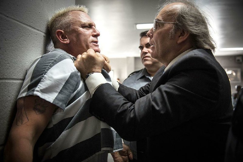 Daniel Craig (left) and Dwight Yoakam star as Joe Bang and Warden Burns in Steven Soderbergh’s Logan Lucky. It came in third at last weekend’s box office and made $7.6 million.