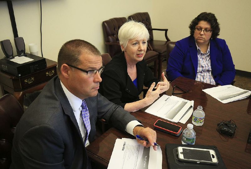 Department of Human Services Director Cindy Gillespie (center), flanked by Craig Cloud, director of aging and adult services, and Dawn Stehle, deputy director for health and Medicaid, talk Thursday to reporters about the department’s new Division of Provider Services and Quality Assurance. Cloud will be director of the new division.