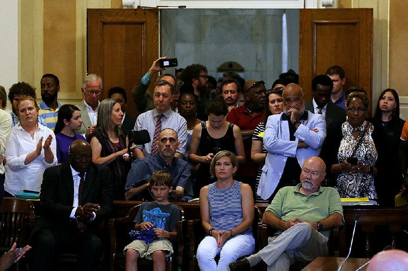 Some of the about 200 people who attended Thursday night’s meeting on Little Rock schools listen as officials take questions.