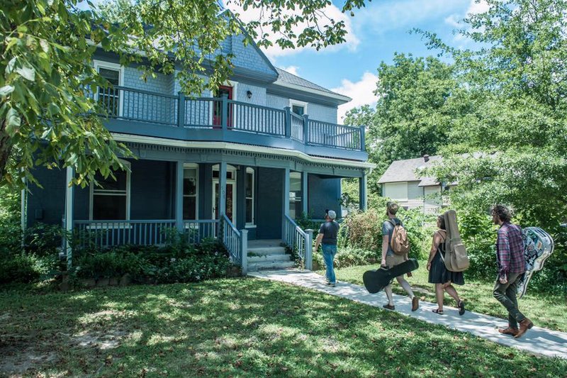 Photo courtesy Jeremy Scott Visiting musicians check out the Bentonville house during the early stages of its new life as The House of Songs Ozarks.