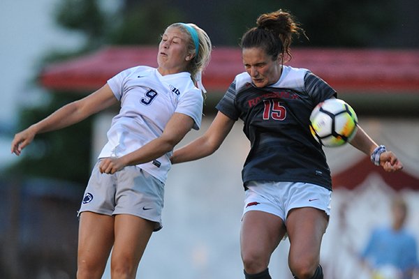 Arkansas' Jessi Hartzler (15) and Penn State's Frannie Crouse (9) leap to head the ball Friday, Aug. 25, 2017, during the Razorbacks' 4-2 loss at Razorback Field in Fayetteville.
