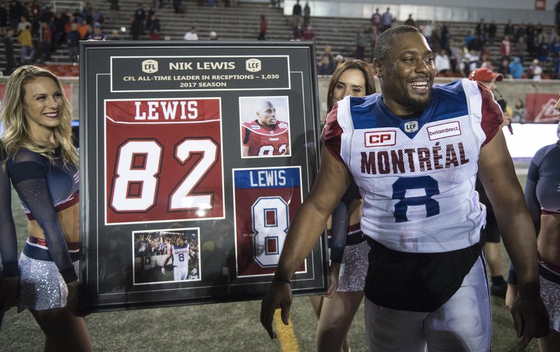 Montreal Alouettes slotback Nik Lewis is honored after becoming the Canadian Football League's all-time leader in pass receptions, following the team's game against the Winnipeg Blue Bombers on Thursday, Aug. 24, 2017, in Montreal. (Paul Chiasson/The Canadian Press via AP)
