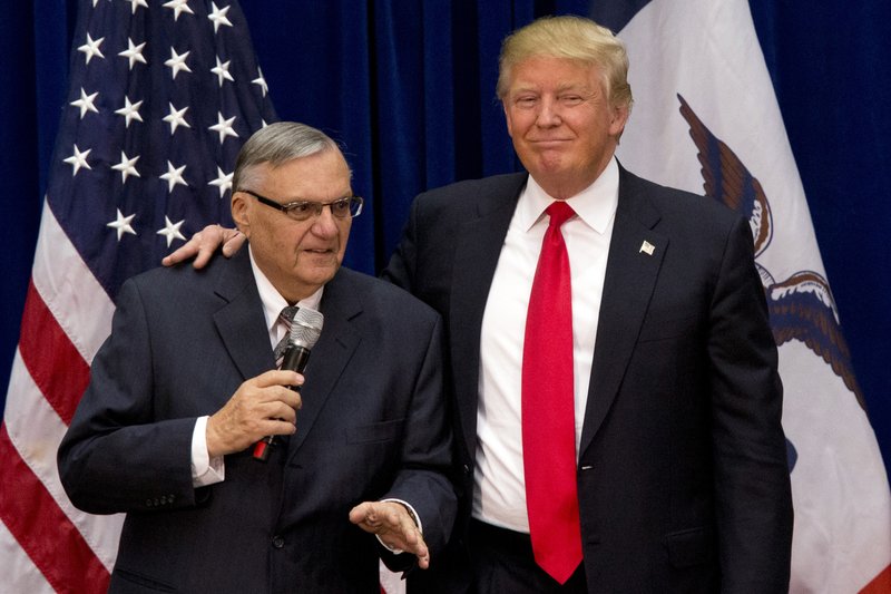 FILE - In this Jan. 26, 2016 file photo, then-Republican presidential candidate Donald Trump is joined by Joe Arpaio, the sheriff of metro Phoenix, at a campaign event in Marshalltown, Iowa. President Donald Trump has pardoned former sheriff Joe Arpaio following his conviction for intentionally disobeying a judge's order in an immigration case. The White House announced the move Friday night, Aug. 25, 2017, saying the 85-year-old ex-sheriff of Arizona's Maricopa County was a "worthy candidate" for a presidential pardon. (AP Photo/Mary Altaffer, File)
