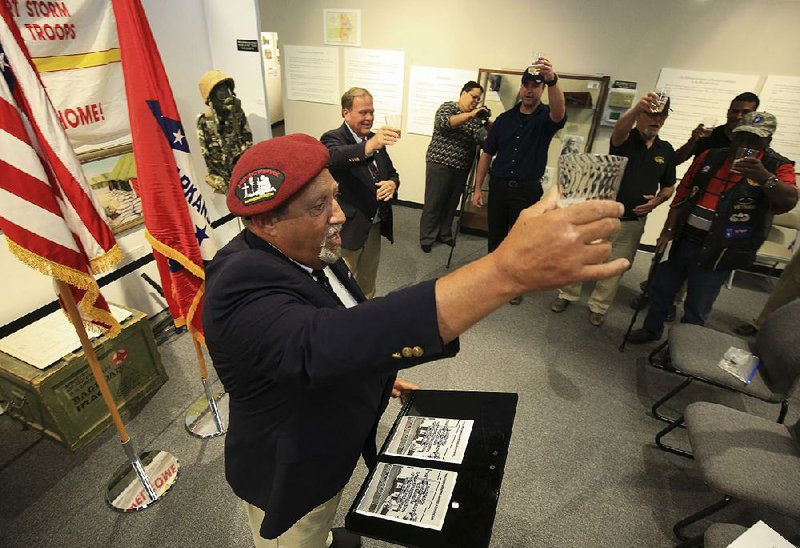 Tommy McMahon, vice president of the 173rd Airborne Brigade Association, raises a toast Friday during a celebration of the 100th anniversary of the brigade at Camp Robinson in North Little Rock.