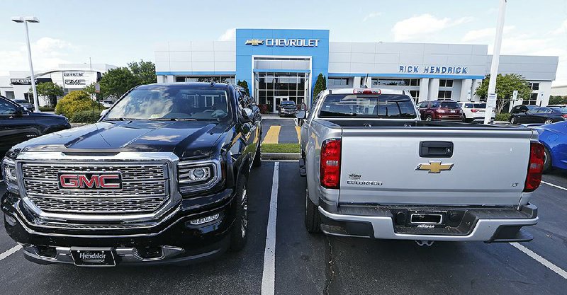 Vehicles await buyers at a Chevrolet dealership in Richmond, Va., earlier this year. Friday’s durablegoods report said orders for vehicles and auto parts dropped 1.2 percent in July. 