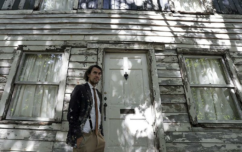 American artist Ryan Mendoza stands in front of civil-rights icon Rosa Parks’ home that he rebuilt in Berlin.