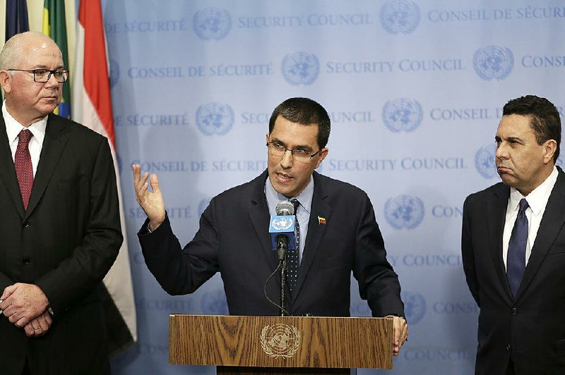 Venezuelan Foreign Minister Jorge Arreaza, (center) speaks to reporters Friday at the U.N., alongside Venezuela’s U.N. Ambassador Rafael Ramirez (left) and former Foreign Minister Samuel Moncada.