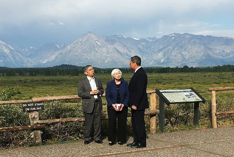 Federal Reserve Chairman Janet Yellen talks Friday with Haruhiko Kuroda of the Bank of Japan (left) and Mario Draghi of the European Central Bank during a break at the Jackson Hole, Wyo., conference.
